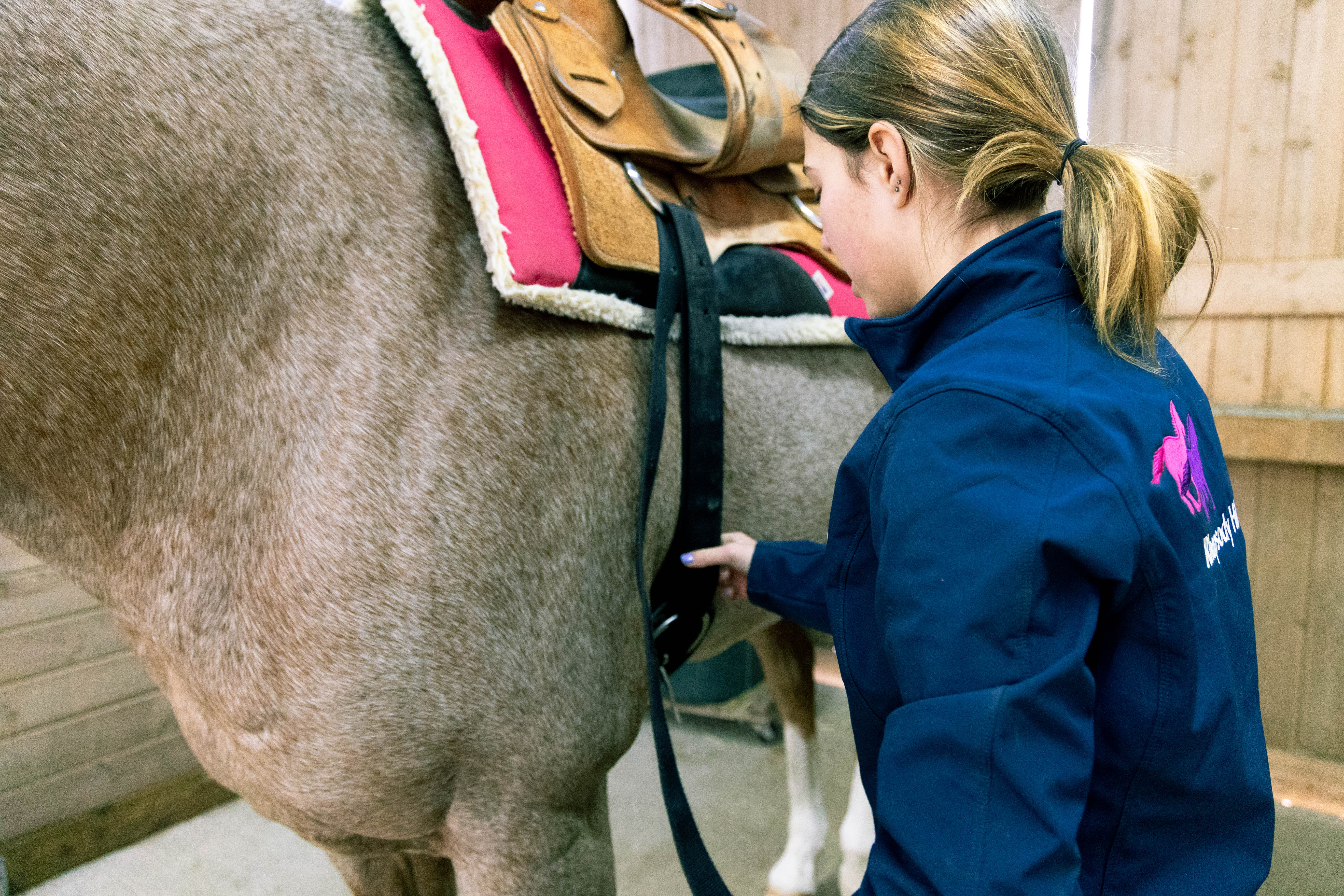 Tacking up races are a great horse camp games that will teach your campers how to tack up horses.